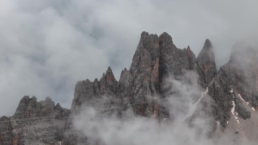 Fog and mist sits on the mountain peak