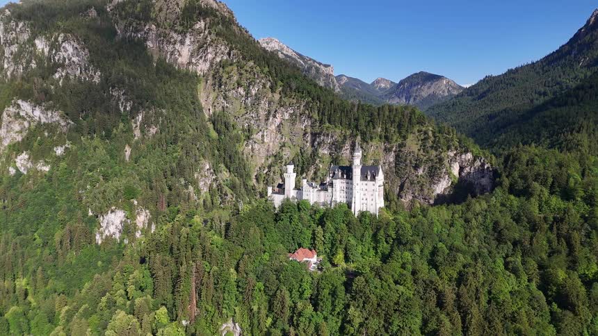 Castle on a greenish hill surrounded by mountains