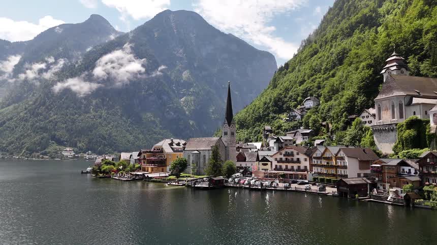 Homes are on the water by the tall mountain