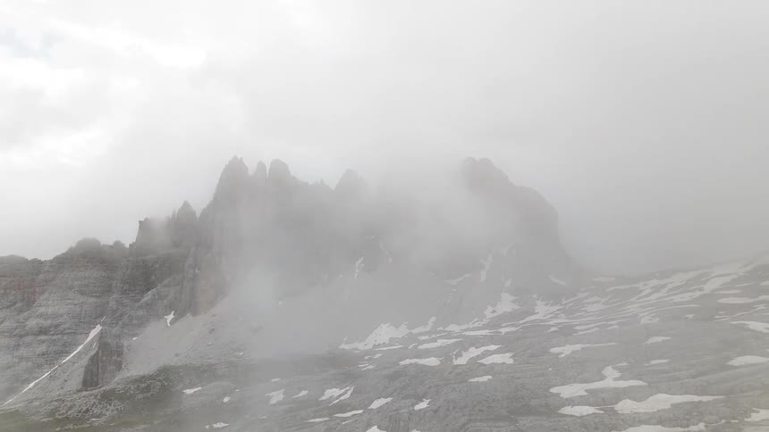 Landscape of peaked mountains with snow on a cloudy day