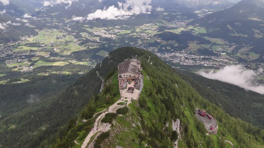 Aerial panorama of a building on a mountain cliff and a city on the horizon