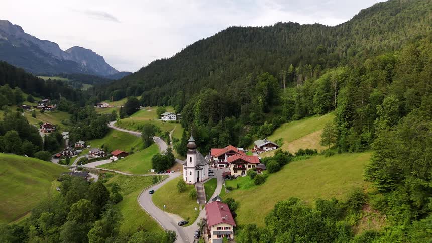 Village sits at the bottom of the mountains surrounded by forest