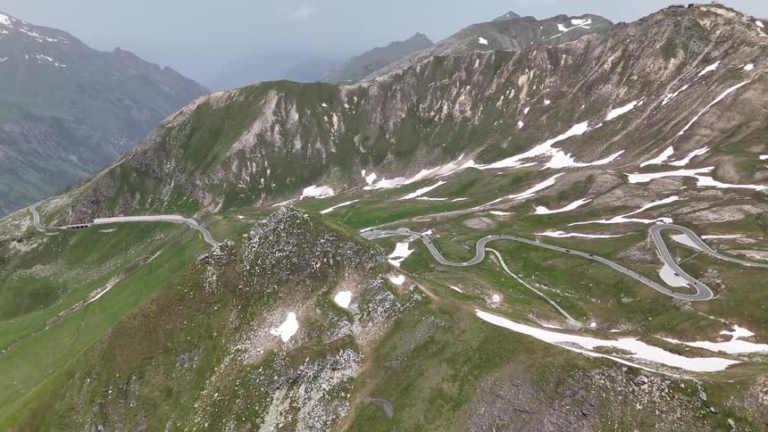 Cars drive on the winding roads on the mountain