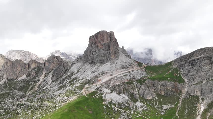Rocky and grassy mountains under a white sky