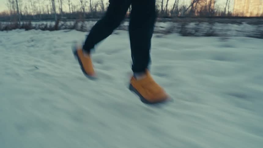 Legs of a person running in the snow