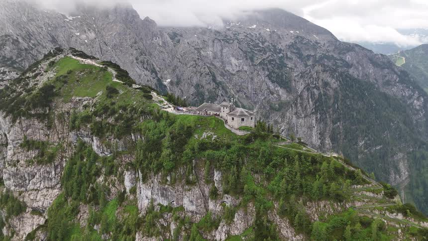 An aerial view of a castle on the top of a mountain