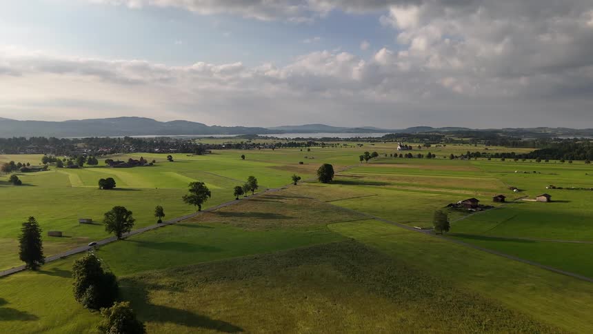 Aerial panorama of green agricultural fields on a partly cloudy day