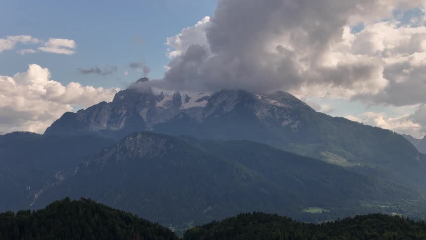 Landscape of a mountainous valley with clouds passing by