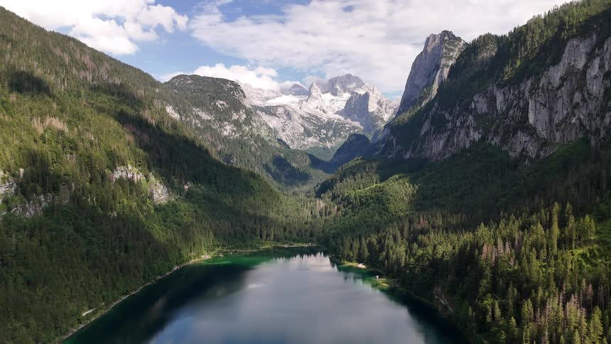 Landscape of a calm lake surrounded by conifers and mountains