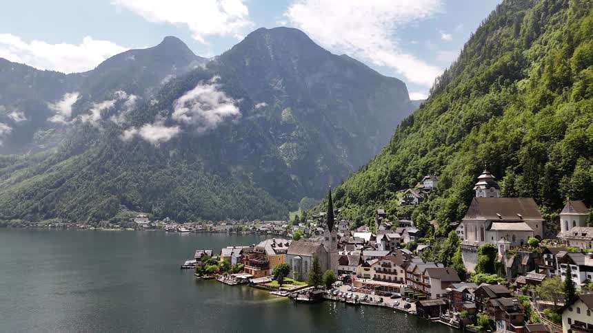 Areal view of the hallsttter see and near by city skyline a mountain landscape in the background
