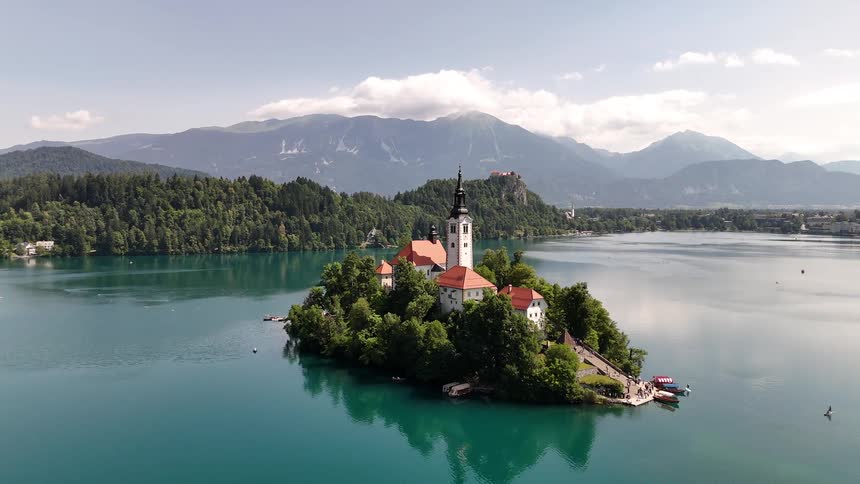 Lake bled in slovenia featuring the assumption of mary pilgrimage church on an island surrounded by mountains and forests
