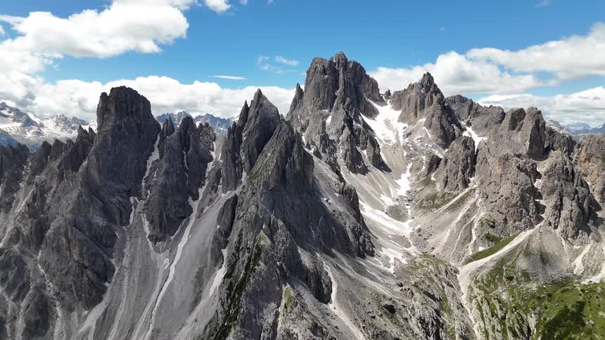 A blue sky is above the tall mountains