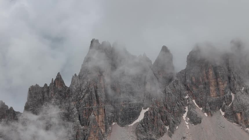 Clouds cover the peak of the mountain