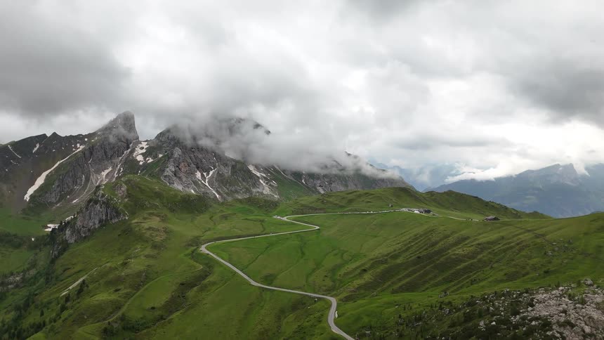 Road cutting through the grass to head to the mountains