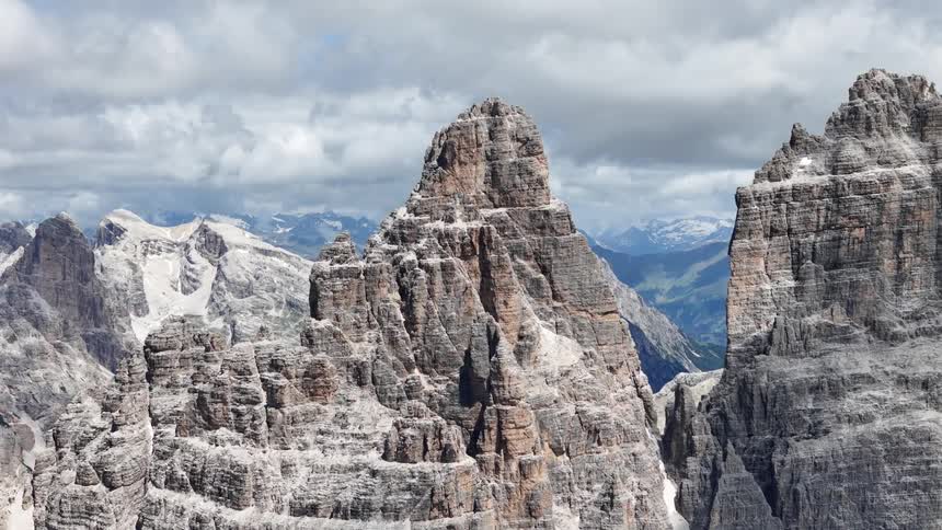 Mountains with sharp peaks and cliffs against a cloudy sky