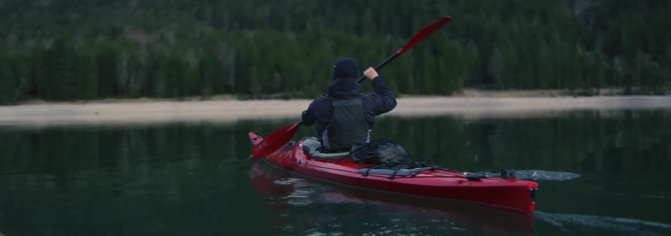 Man in a red kayak in calm water
