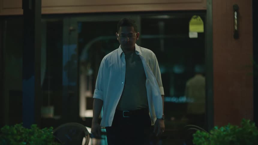 An asian man walks away from a locked door