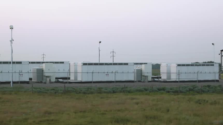 Large battery electrical equipment behind a metal fence