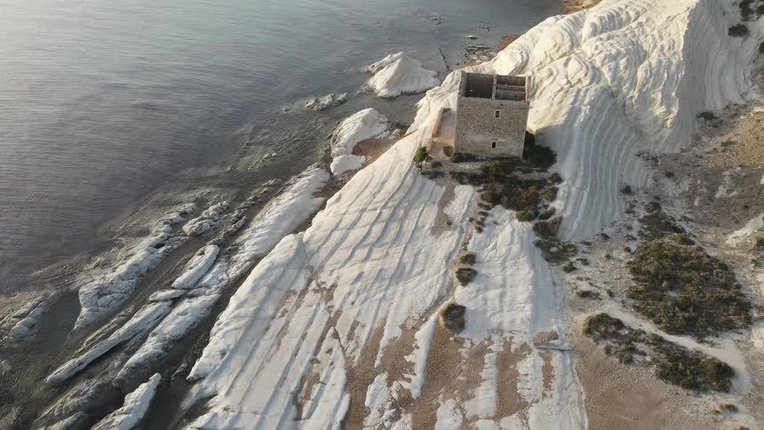 A building sits on a coastal area