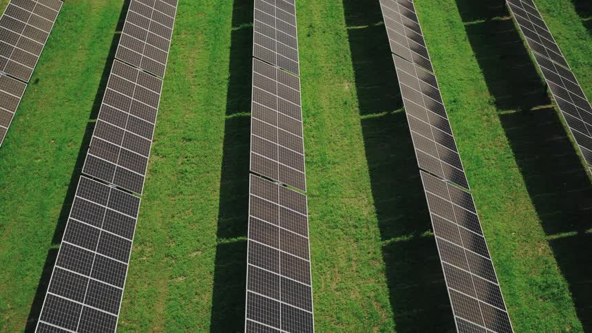 Aerial view showing many solar panels standing in the sun