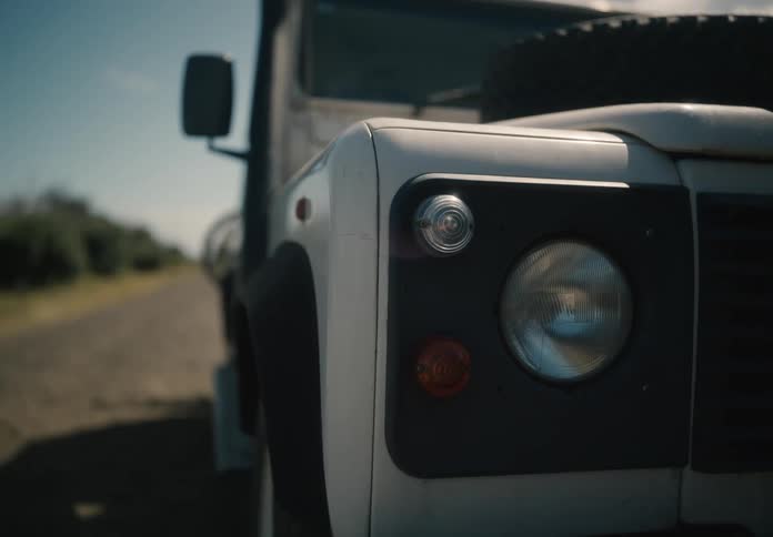 Person entering a vehicle and the front headlights being turned on