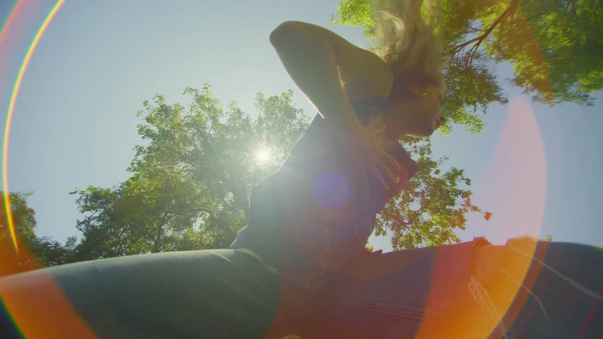 Woman in jeans dancing alone among trees