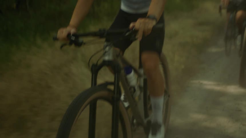 A person riding a bicycle through a forest path