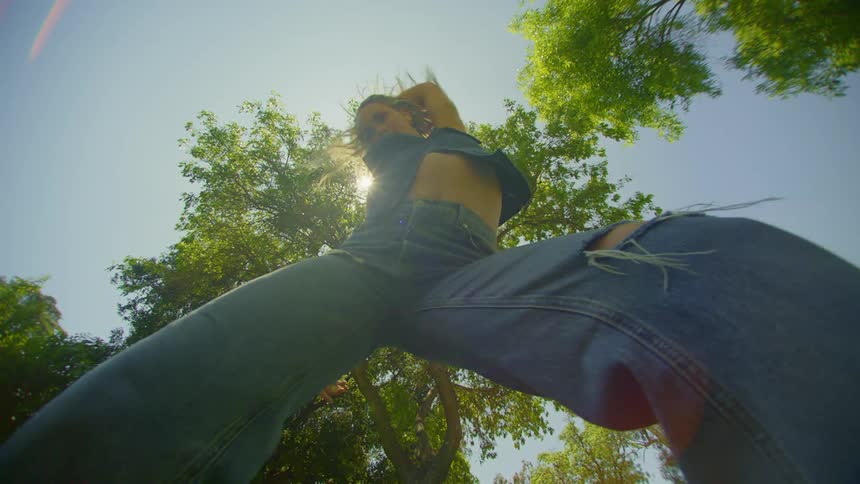 Woman in a place with trees around her dancing