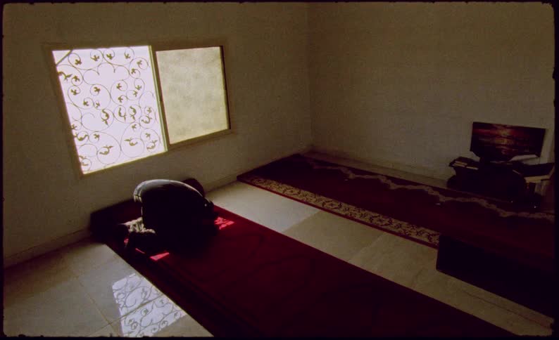 A person is praying indoors