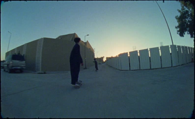 Young teenagers skateboarding on a narrow street