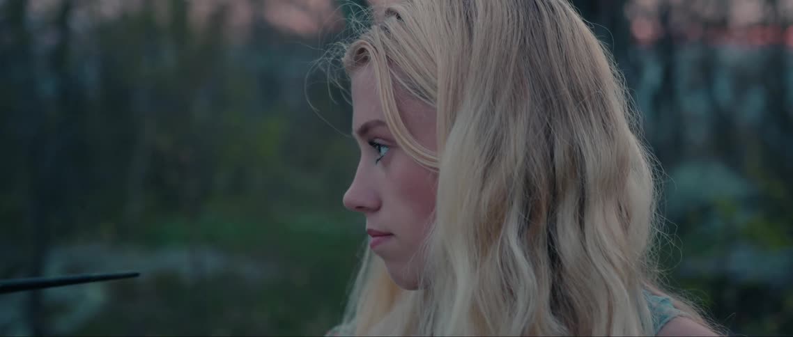 Side portrait of a concentrated blonde painting