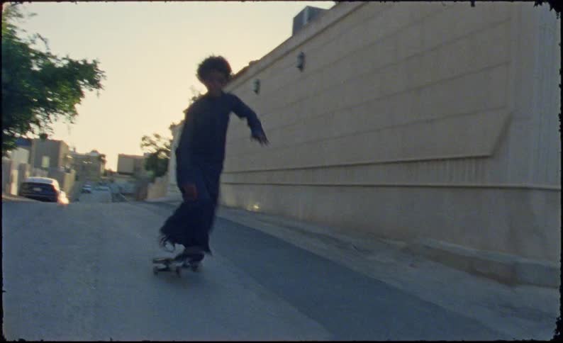 Teenagers skateboarding on a street in the city