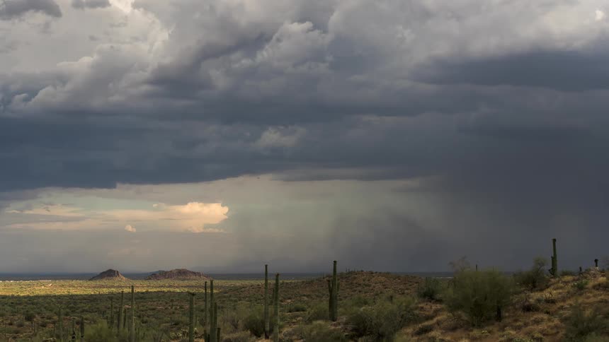 Panorama of a desert landscape with hazy storm clouds passing by