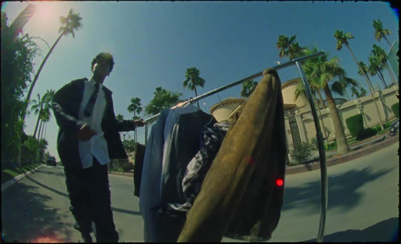 Teenager in formal clothes walking through the streets with a mobile clothesline