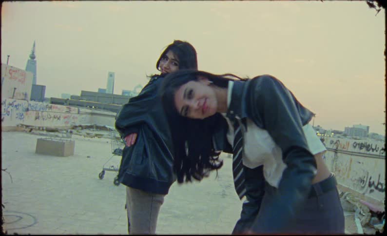 Two female models in college clothes in an abandoned environment