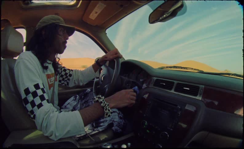 Man driving a car in a desert environment