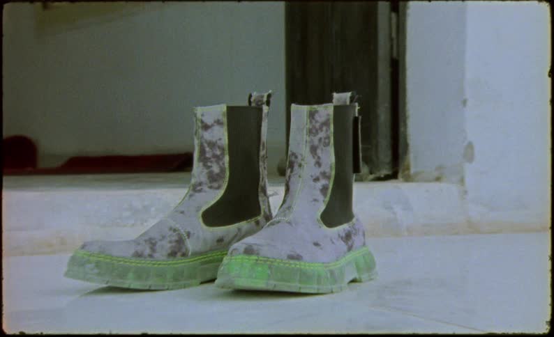 Camouflage boots on a white floor