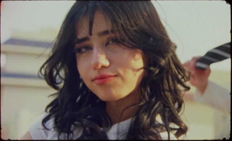Close up of a young model with long hair looking at the camera