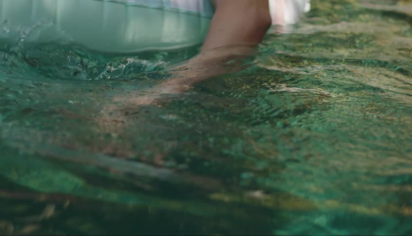 Woman floats on a tube in the water