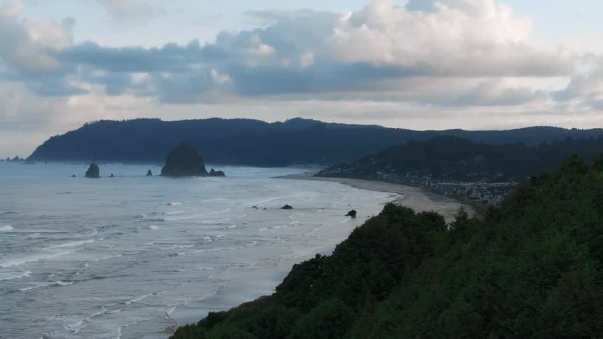 Aerial view of a coastal town with prominent rocks formation near the coast