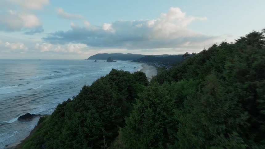 Aerial view of a coastal town with prominent rocks formation near the coast