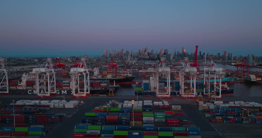Aerial view of a loading dock with multiple cargo boats and containers