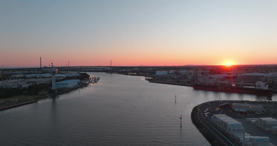 The water is surrounded by buildings roads and storage containers on every side