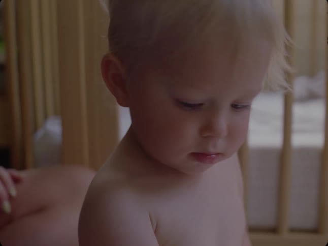 A mother keeps watch on her toddler son