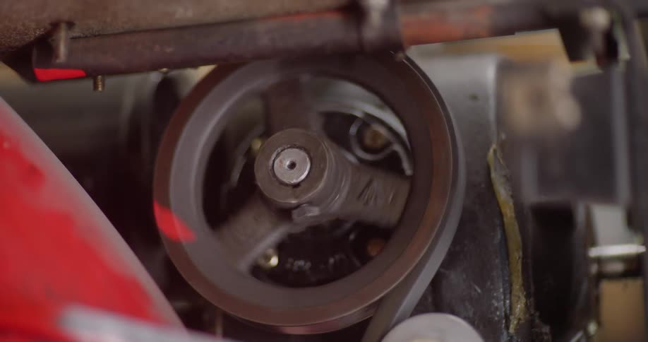 A circular pulley of rusty iron rotating on its own axis