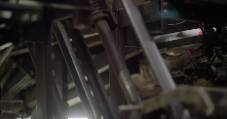 A machine at a bowling alley returns a bowling ball