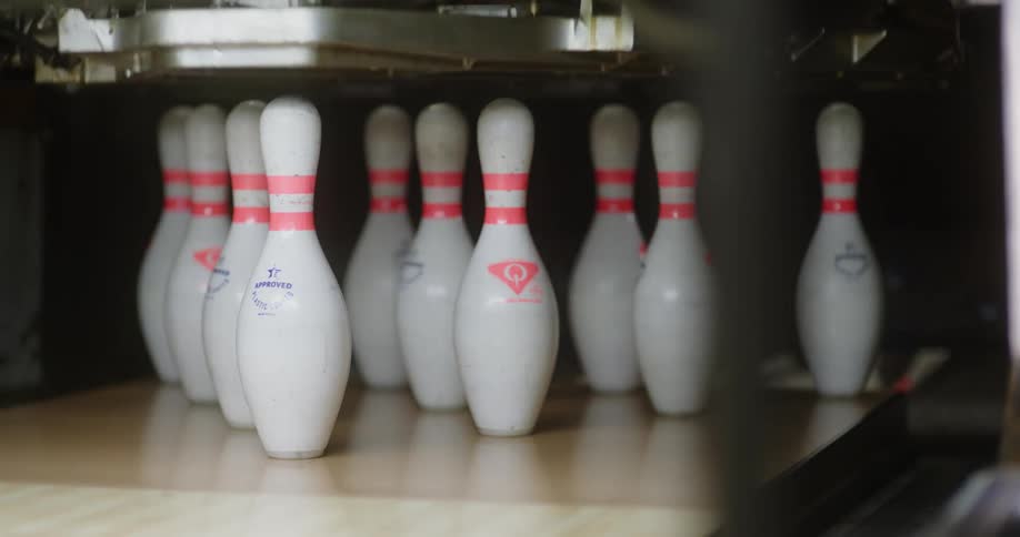 A bowling pin replacement machine removing the missing ones and leaving them all standing