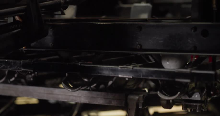 Bowling pins dropping from a machine before falling onto the end of a lane