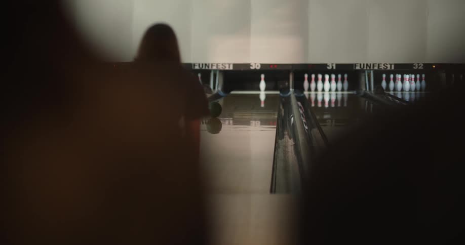 Person on a court throwing a bowling ball