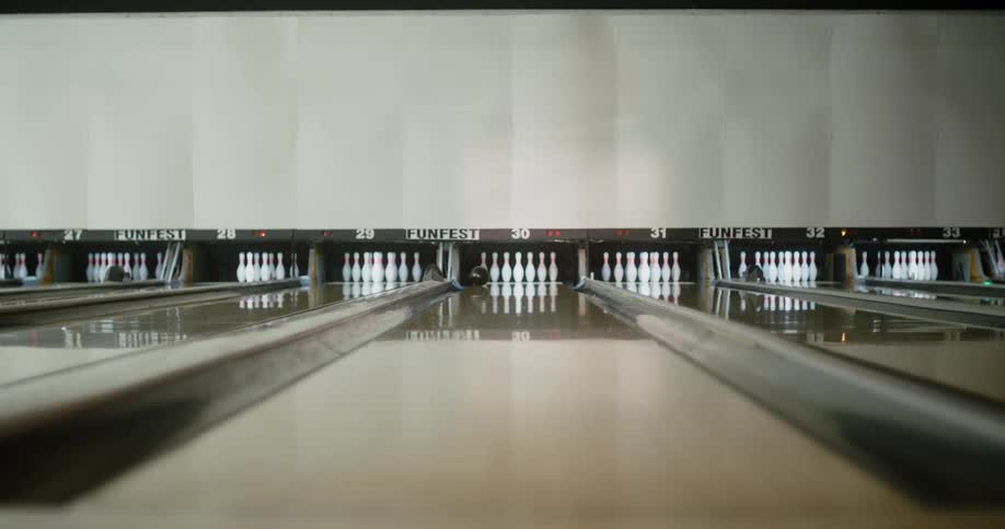 Woman throwing a bowling ball on the court